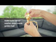 a person is holding a golden ball in their hand and the words make sure rubber washer stays inside