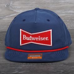 Vintage Budweiser Beer Patch on a Richardson 256 Umpqua Snapback Hat Shape Flip-Up Stay Pinch Fabric Cotton/Nylon Visor Flat Sweatband Cotton Material 70% Cotton, 30% Polyester Construction Woven Adjustable Snapback OSFM (7 - 7 3/4) Hats are shipped in a poly bag and placed in a box to protect the hat.