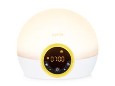 an alarm clock is sitting on top of a white surface with the word umme written below it