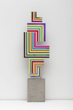 an abstract sculpture with multicolored lines on it