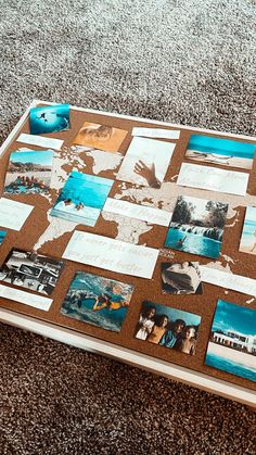 a wooden table topped with pictures and papers on top of carpeted floor next to wall