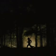 a man running through the woods at night