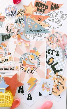 many different types of stickers on a white surface with scissors and other items around them