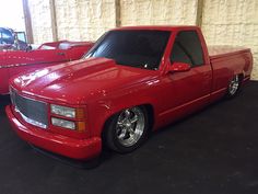 a red pick up truck parked in a garage