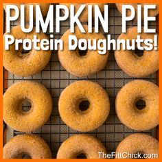 pumpkin pie protein doughnuts on a cooling rack with the words, pumpkin pie protein doughnuts