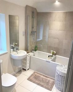 a bathroom with a sink, toilet and bathtub next to a shower stall in the corner