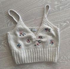 a knitted crop top with flowers on it