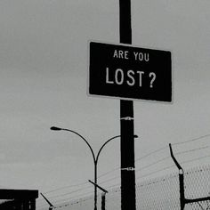 a black and white photo of a street sign with the words are you lost?