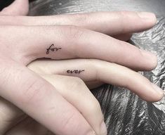 two fingers with the words for ever tattooed on them