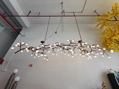 a chandelier hanging from the ceiling in a room with yellow flowers on it