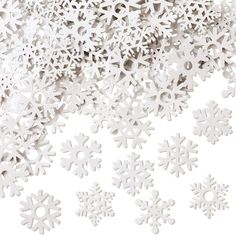 white snowflakes are scattered on a white background