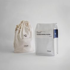 a white bag next to a black and white bag with the word chani written on it