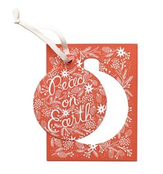 a christmas ornament with the words peace on earth in red and white lettering