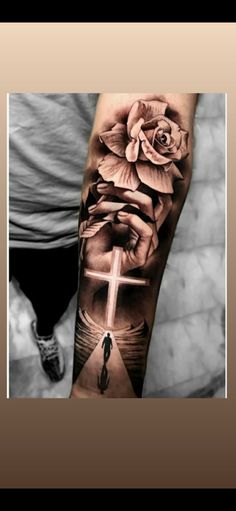 a person with a cross and flowers on their arm