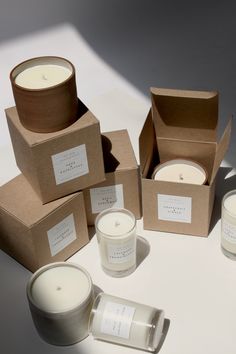 several candles and boxes sitting on a table