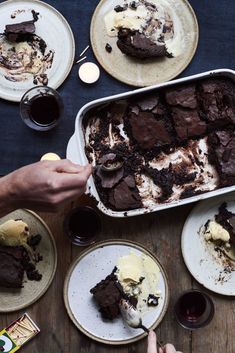 people are eating cake and ice cream on the table