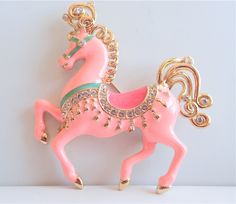 "Bob Mackie pink Carousel Pony brooch pin accented with a darker pink saddle and surrounded with sparkling crystals beckoning one to jump on for a ride! Measures 3\" L X 2 3/4\"W. Perfect condition, substantial in weight and ready to be flaunted by you, or given as a wonderful gift. Signed Bob Mackie." Pink Saddle, Pink Carousel, Horse Brooch, Vintage Bob, Carousel Horse, Carousel Horses, Bob Mackie, Pearl Brooch, Sparkling Crystal