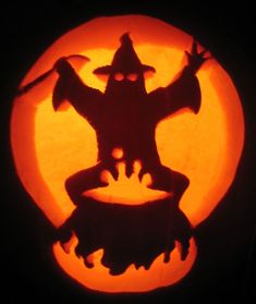 a carved pumpkin with an image of a scarecrow in front of a full moon