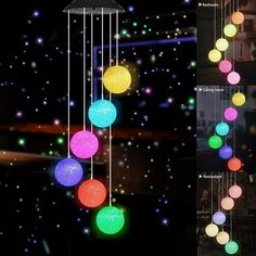 several different colored lights hanging from the ceiling in front of a black background with stars