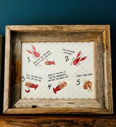 an old wooden frame with red lobsters on it