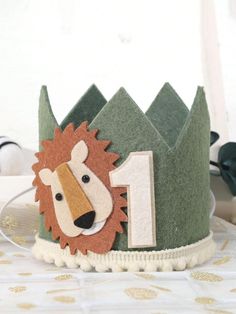 a paper crown with a lion on it's face and number one in the middle