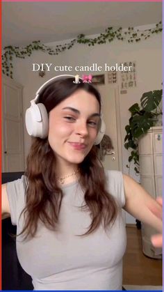 a woman wearing headphones with the words diy cute candle holder on her face