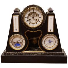 an antique clock with three different clocks on it's sides, all in gold and black