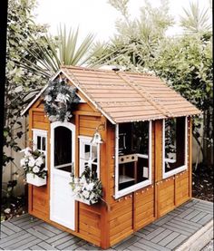 a small wooden dog house in the backyard