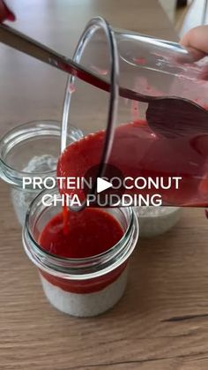 someone pouring red sauce into small jars on a wooden table with text that reads protein coconut chia pudding