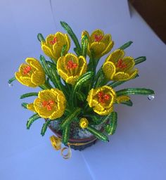 a small potted plant with yellow flowers