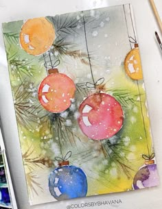 a watercolor painting of christmas ornaments hanging from a tree