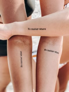 two women with tattoos on their arms and one has the words no matter where in black ink