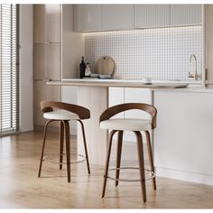 two wooden stools sitting in front of a counter