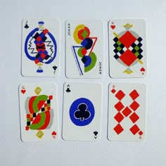 four playing cards with different designs on them, all in the same color and shape