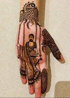 a woman's hand with henna tattoos on it