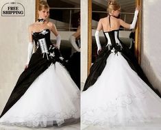 a woman in a black and white wedding dress is looking at herself in the mirror