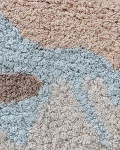 a close up view of a rug with different colors and patterns on it's surface