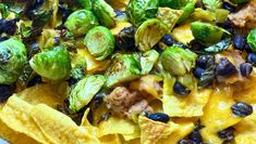 a bowl filled with tortilla shells, black beans and brussel sprouts