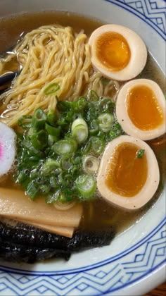 a bowl filled with ramen and boiled eggs