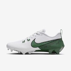 the white and green nike vapor soccer shoe is shown in front of a white background