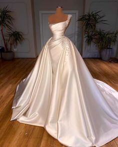 a white wedding dress on display in a room