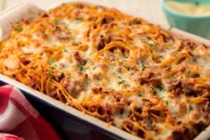 a casserole dish filled with meat and cheese