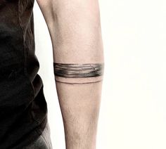 a man with a black and white tattoo on his arm