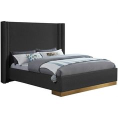 a bed that is made up and has pillows on the headboard, along with throw pillows