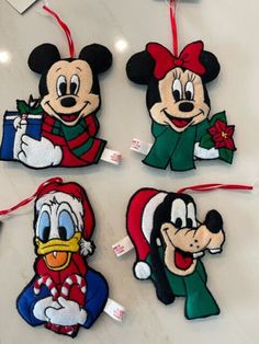 four mickey mouse ornament hanging on a wall