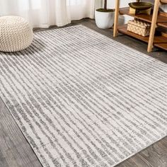 a white and gray area rug in a living room