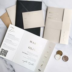 wedding stationery and money laid out on a marble table