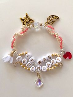 a bracelet with beads and charms that says get well, be happy on it's side