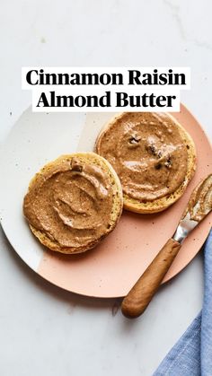 two peanut butter sandwiches on a pink plate with a knife and fork next to it