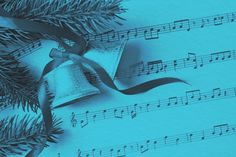 a sheet with music notes and a bell on it next to a christmas tree branch